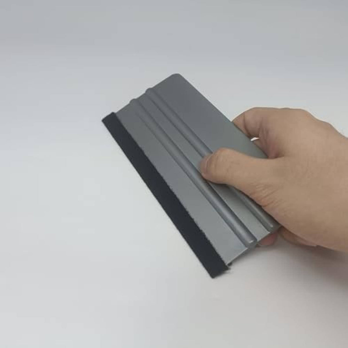 Handheld vinyl wrap felt squeegee, gray plastic with black felt for smoothing vinyl
