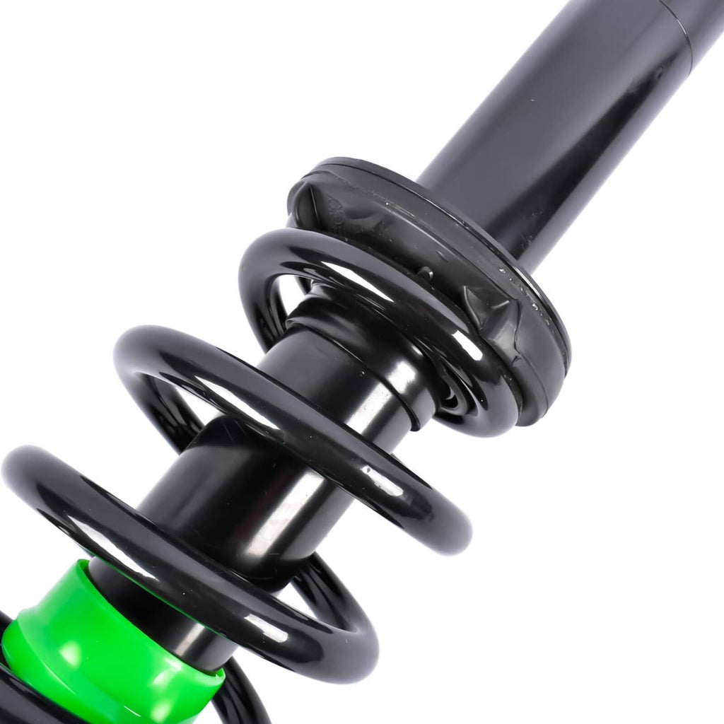 Close-up of black shock strut with coil spring and green protective ring