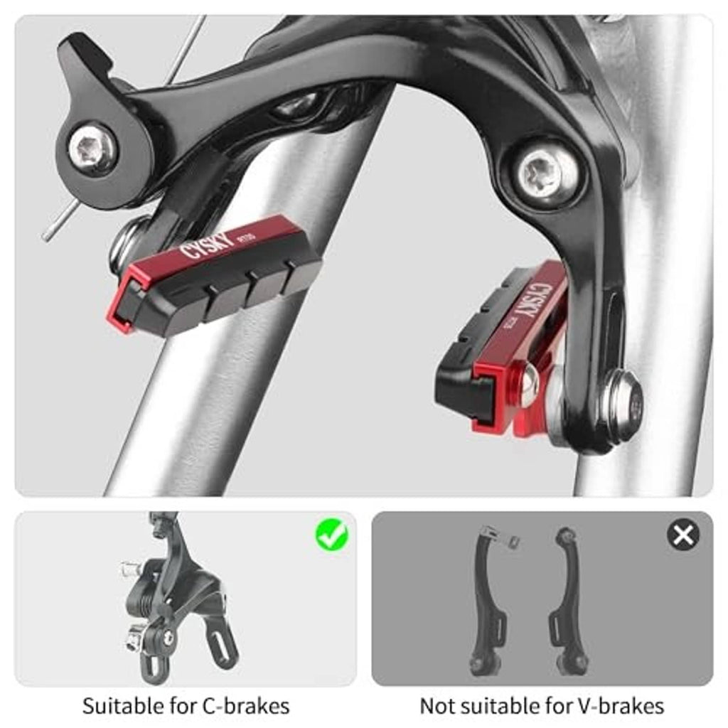 C-caliper brake pads mounted on bicycle fork with red adapter hardware