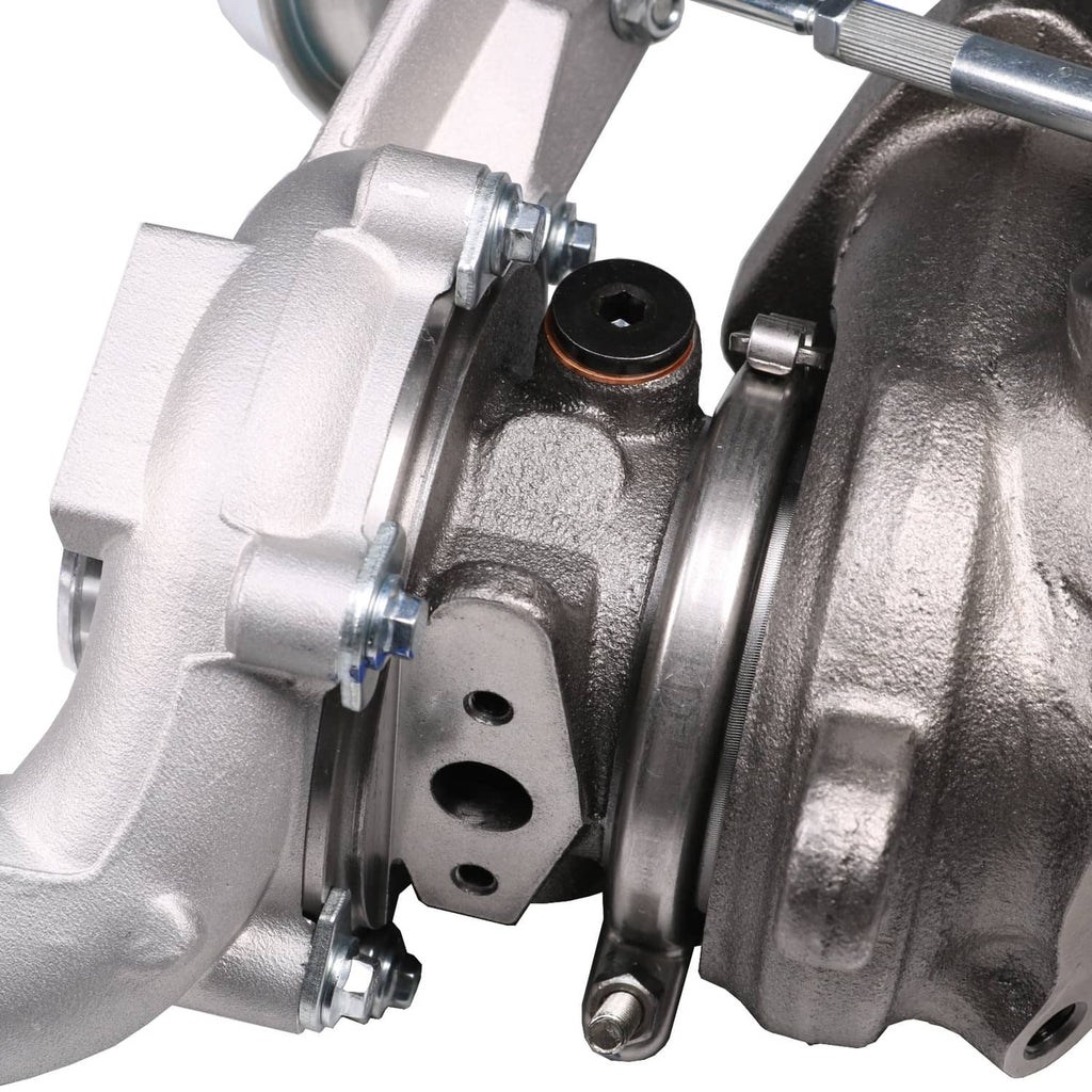 Close-up of turbocharger bearing housing and connecting lines on cast metal body