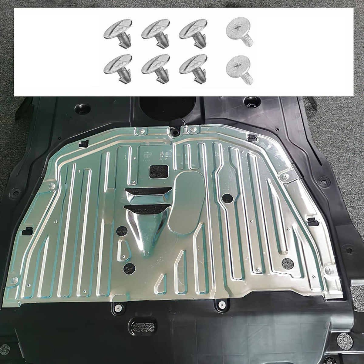 Silver splash guard shield panel with mounting holes and screws laid out