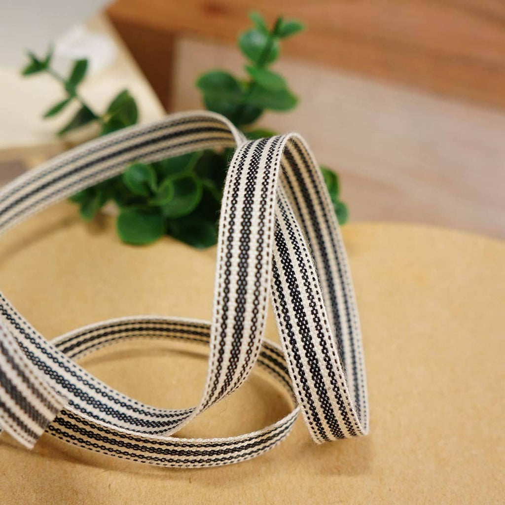 Ivory and black striped ribbon with bow detail, close-up view