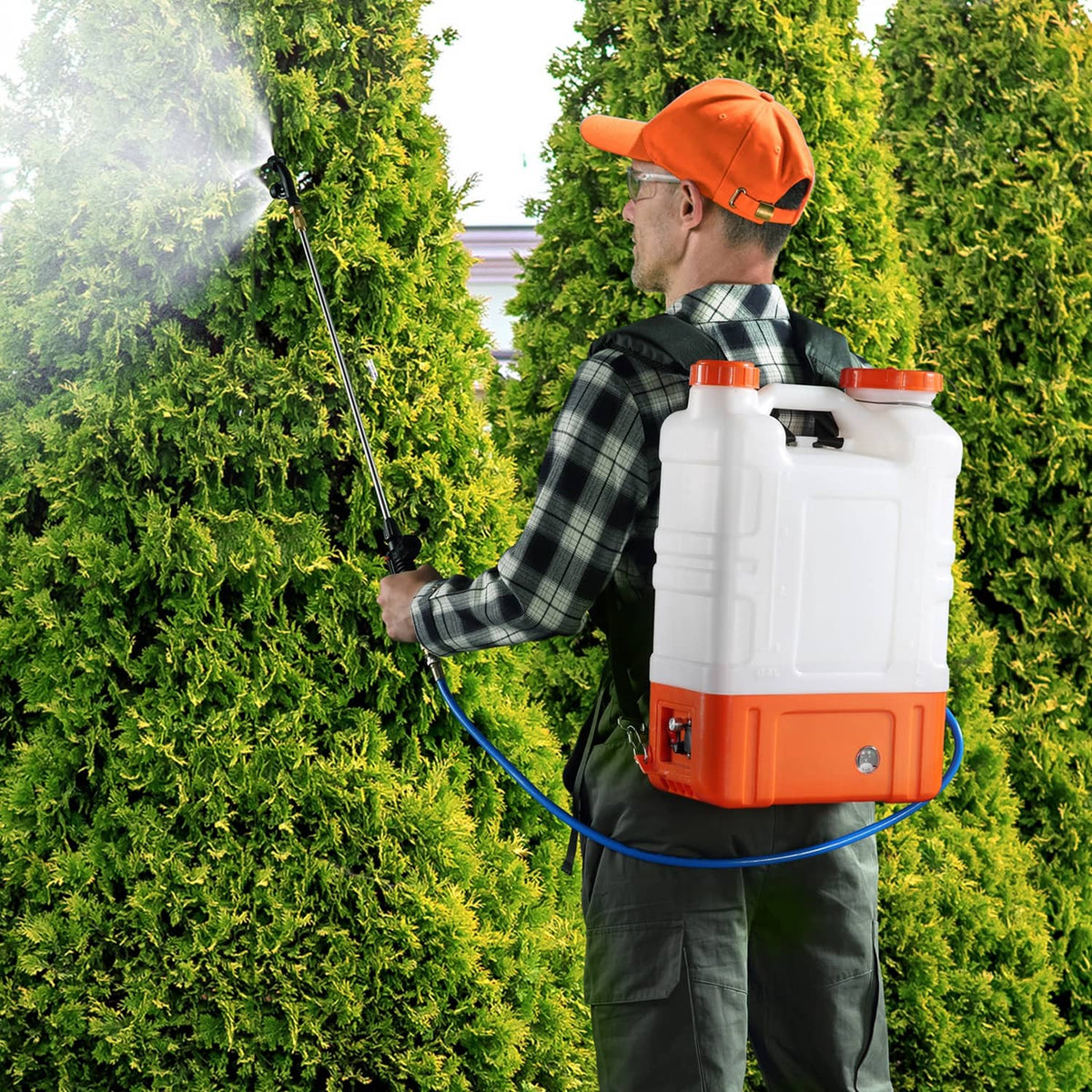 Operator spraying greenery with wheeled battery sprayer cart, white tank and orange pump housing