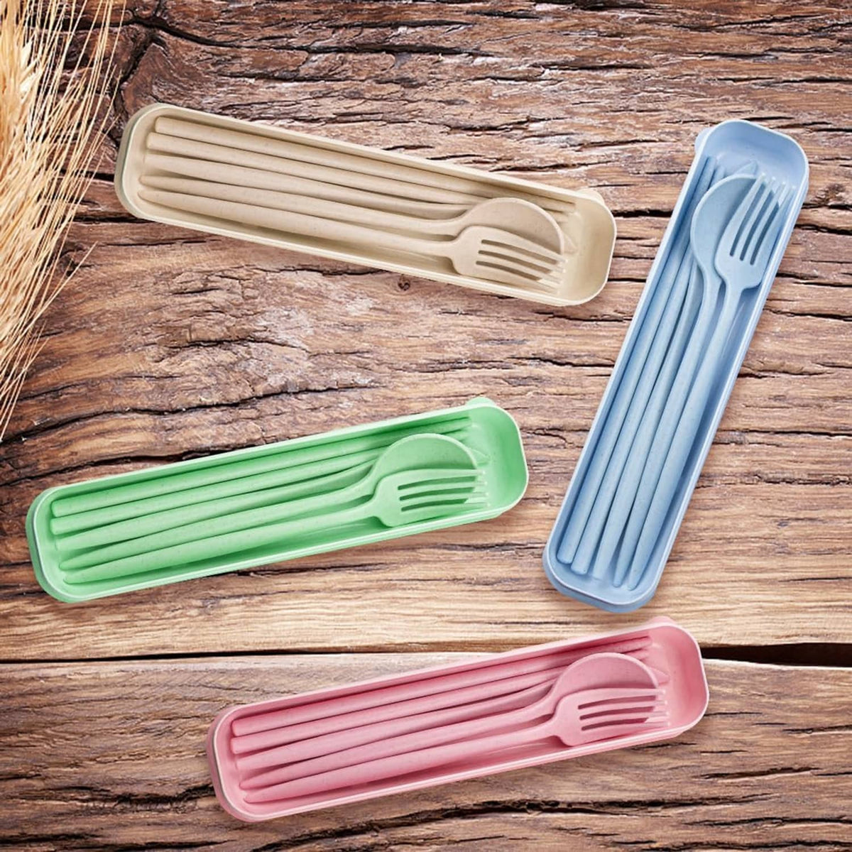 Reusable travel cutlery set with pastel utensil cases (beige, blue, green, pink) on wood