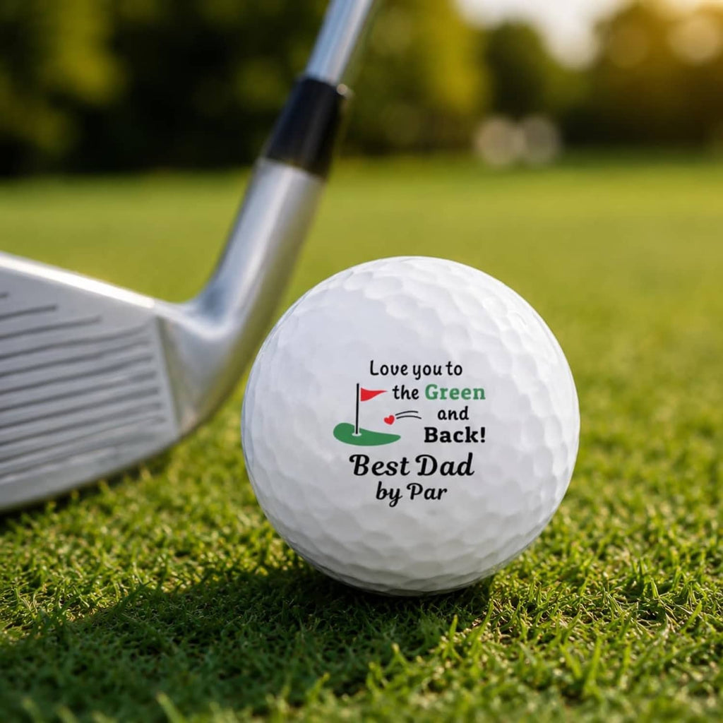 White golf ball on grass near a golf club head