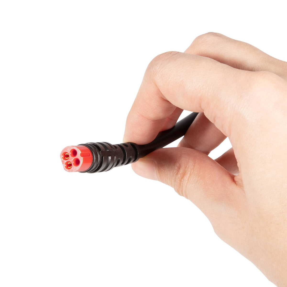 Hand holding black power cable plug with orange-red 3-pin connector end.