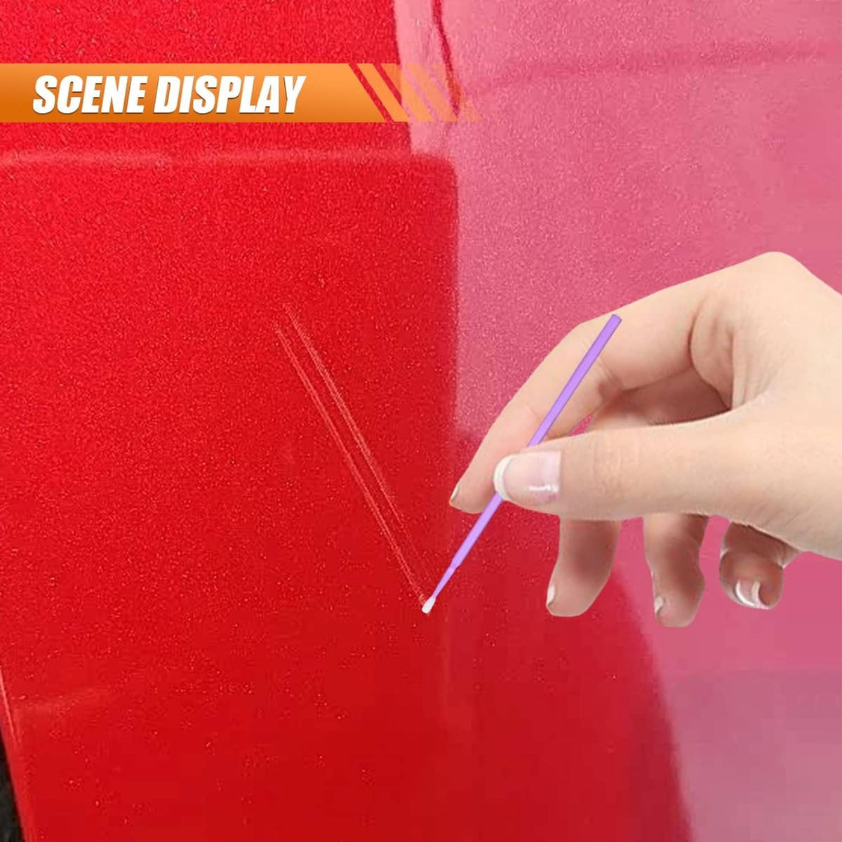 Purple paint pen applying fine lines on a red car panel