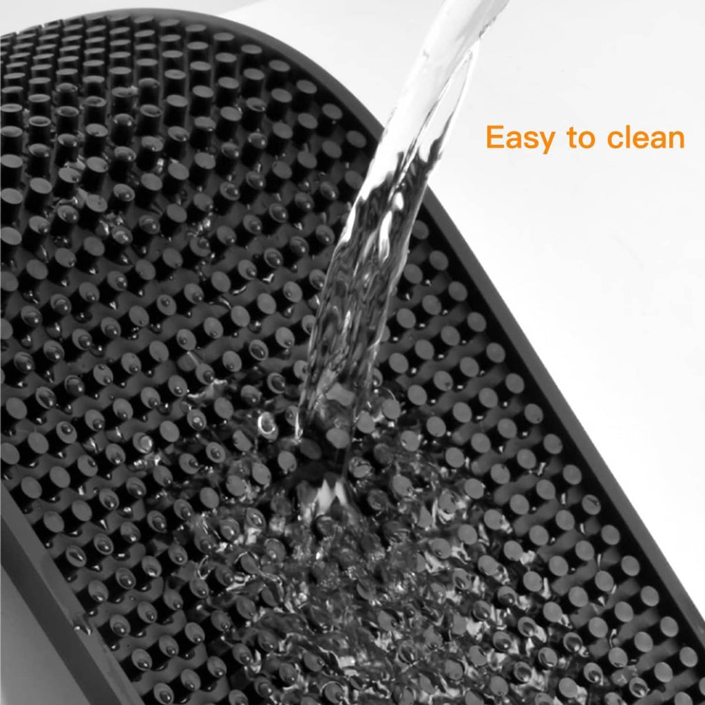 Black rubber bar mat with raised dot texture and water droplets for easy cleaning