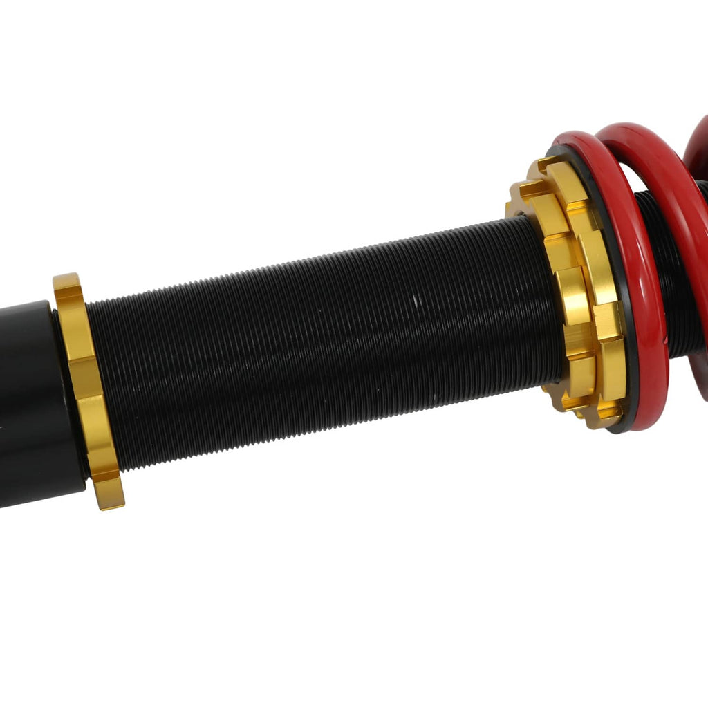Close-up of black threaded coilover body with gold ring and red spring