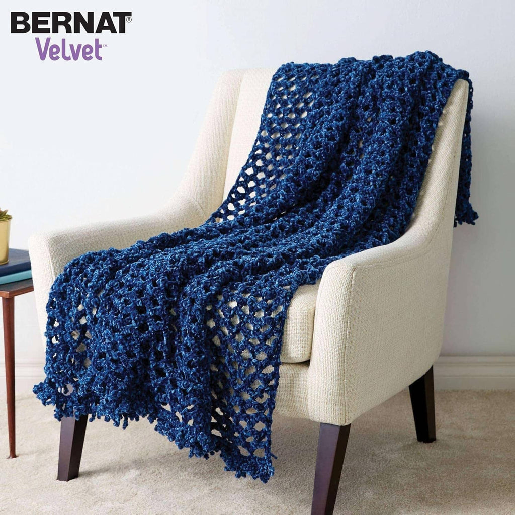 Blue textured knit throw blanket draped over a chair arm
