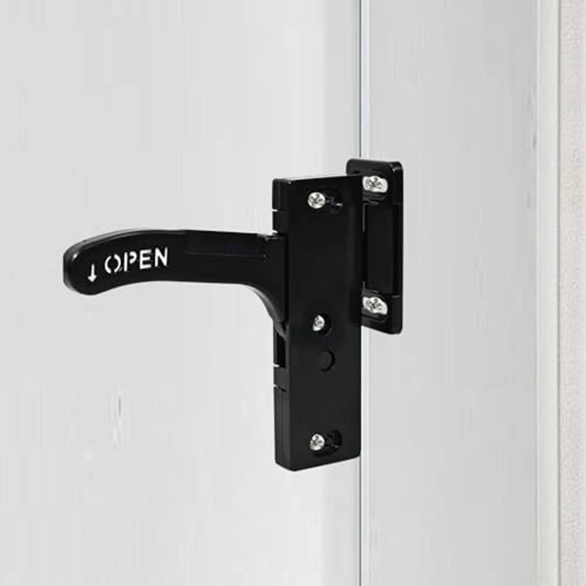 Black RV screen door latch handle replacement attached to a door frame
