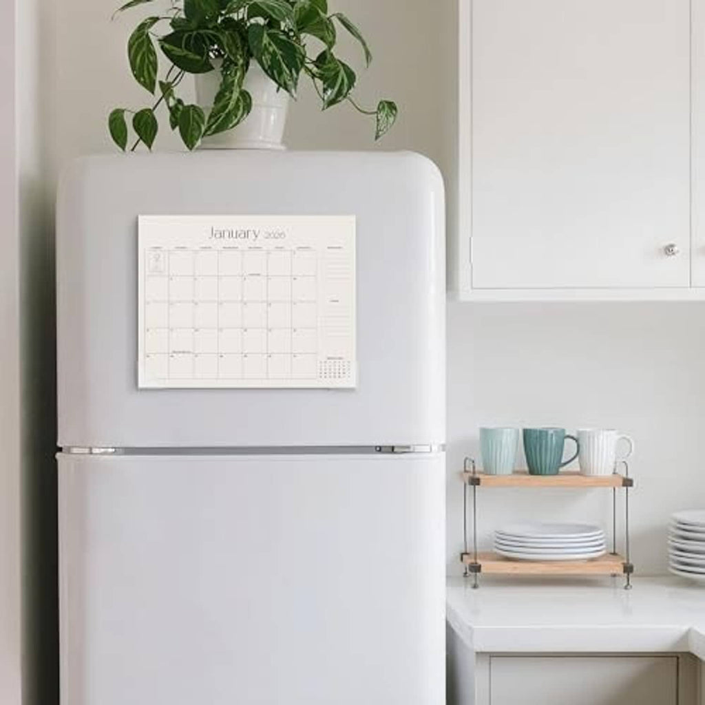 Refrigerator magnetic calendar on white fridge door, showing January 2026 grid