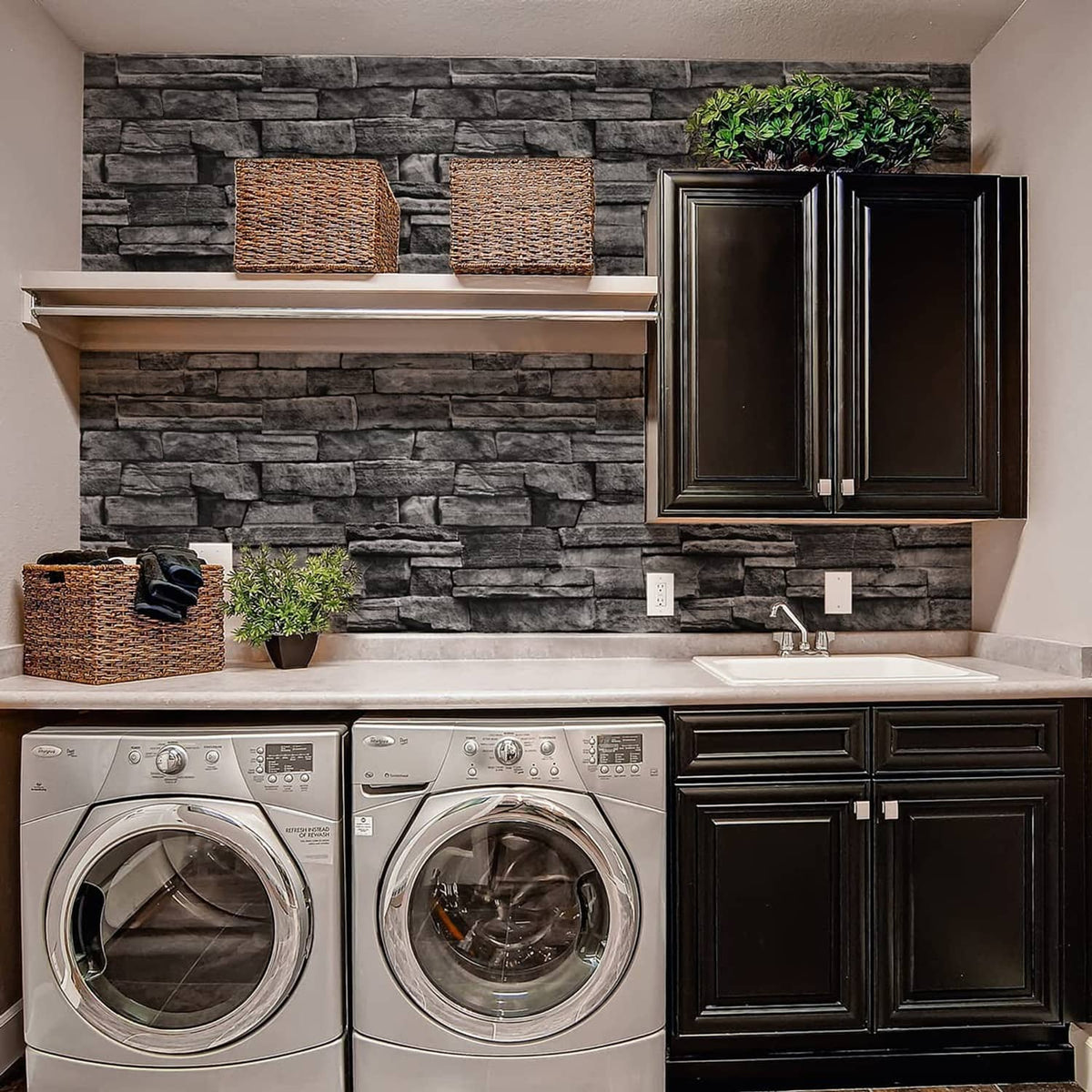 Dark gray brick-pattern wallpaper on a kitchen backsplash behind cabinets.