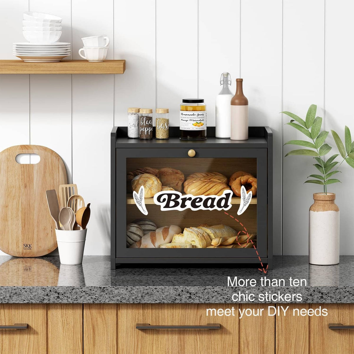 Black bread storage cabinet with open door and two shelves for pastries and packaged goods
