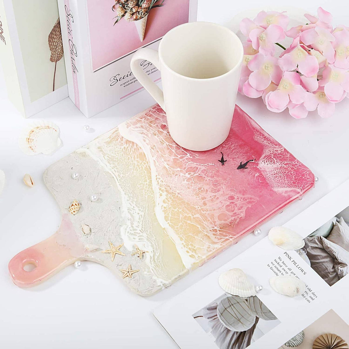 Rectangle resin cutting board with pink, white, and beige marbling in silicone tray shape