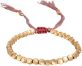 Gold-tone bead bracelet with red braided knot and multicolor cord tassels.