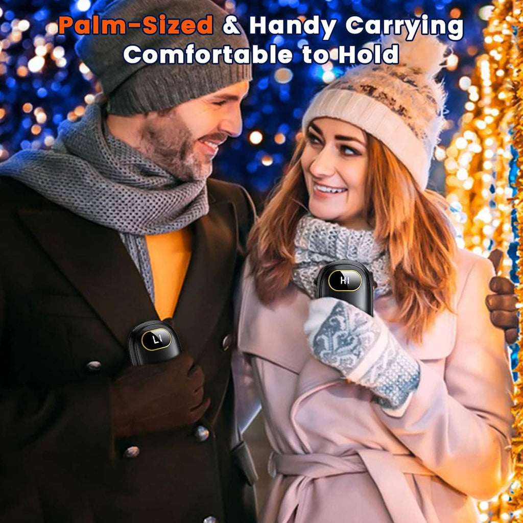 Palm-sized rechargeable hand warmers with LED display, held close by winter clothing