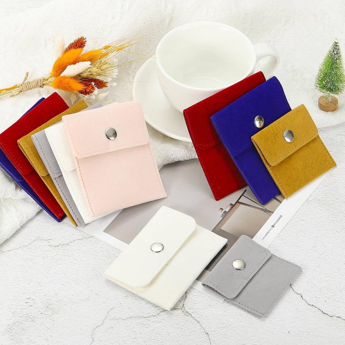 Assorted velvet jewelry pouches with metal snap-button closures