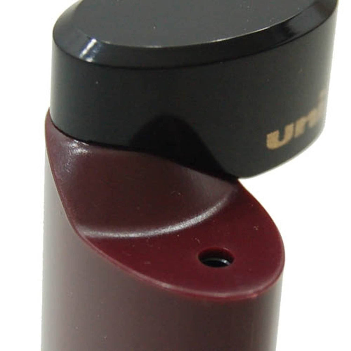 Pocket pencil sharpener close-up showing black top and maroon blade opening