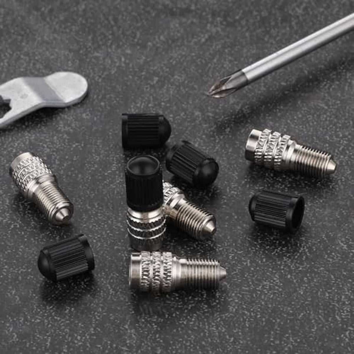 Metal valve stem extension caps with black tops and textured grip rings