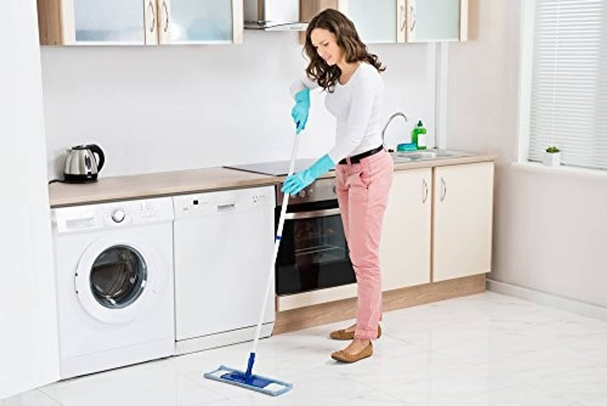 Teal nitrile rubber cleaning gloves worn while cleaning a kitchen floor
