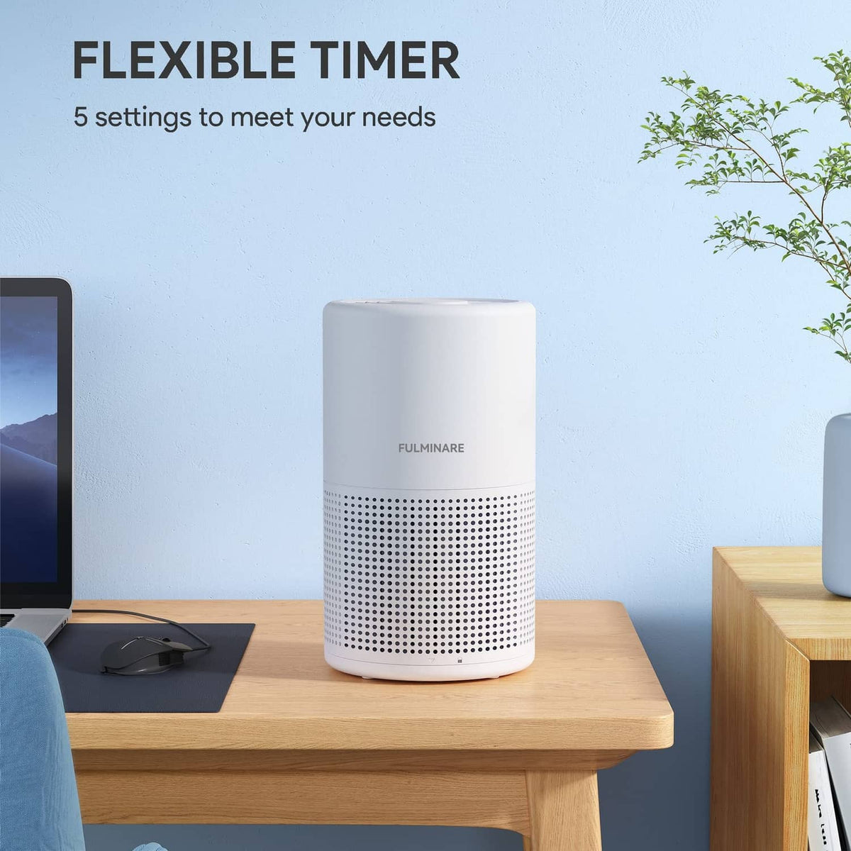White cylindrical air purifier on a wooden table with front air intake grille.