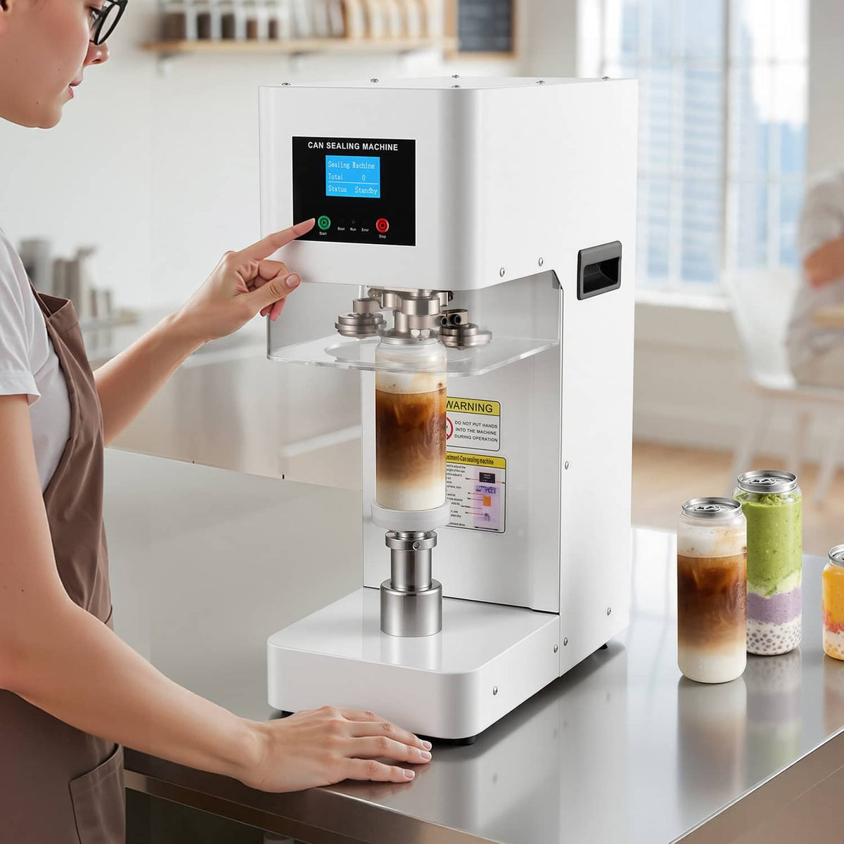White automatic can sealer with screen control panel, sealing head above an open can.