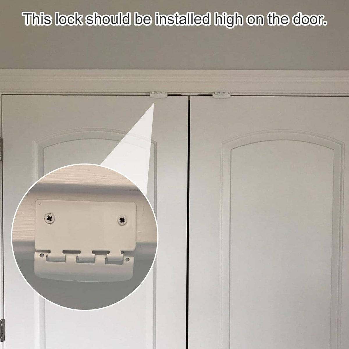 White flip action door lock installed high on a door, showing latch mechanism