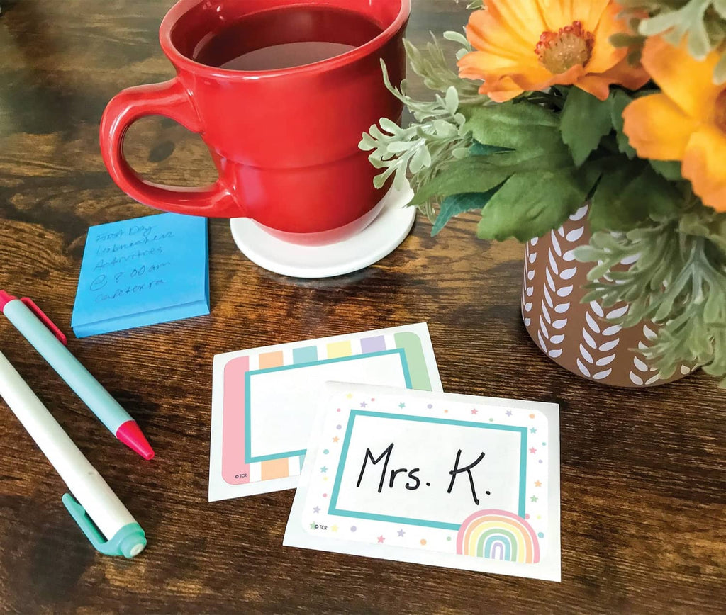 Pastel pop name label for Mrs. K with rainbow corner accents on paper