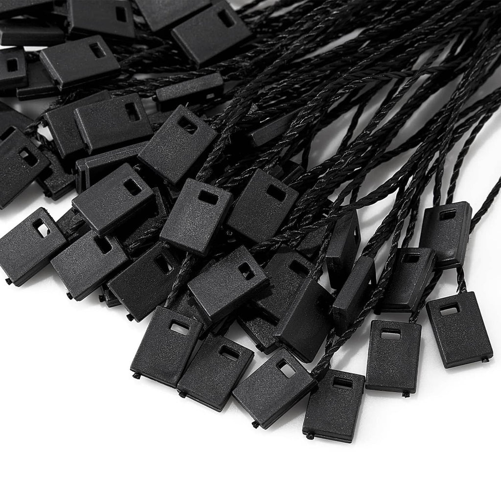 Cluster of black snap-lock clip ends attached to loop strings for hang tags