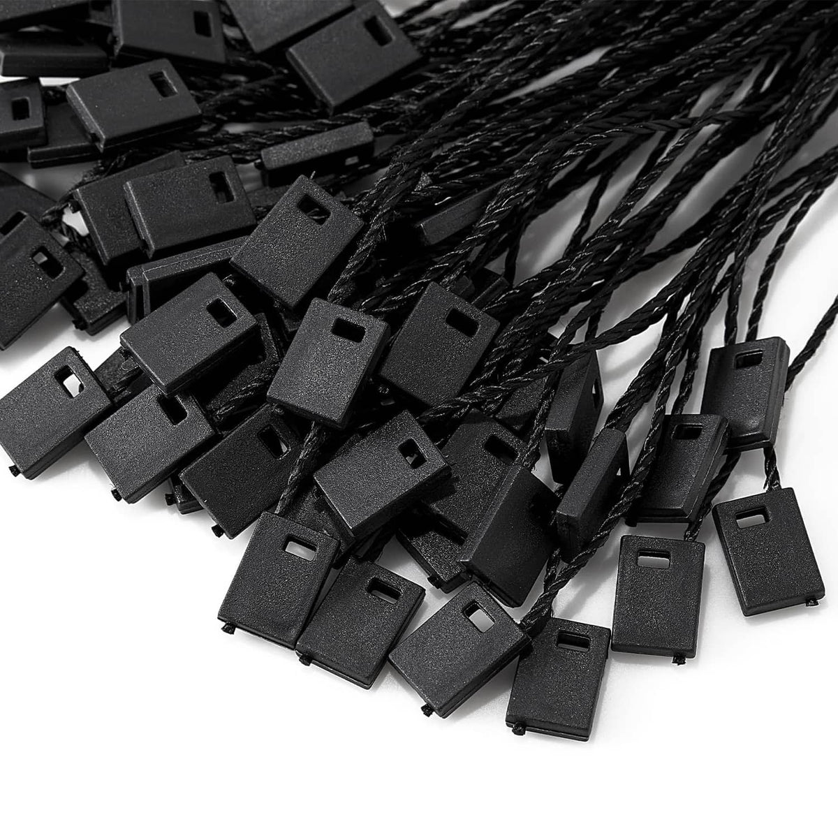Cluster of black snap-lock clip ends attached to loop strings for hang tags