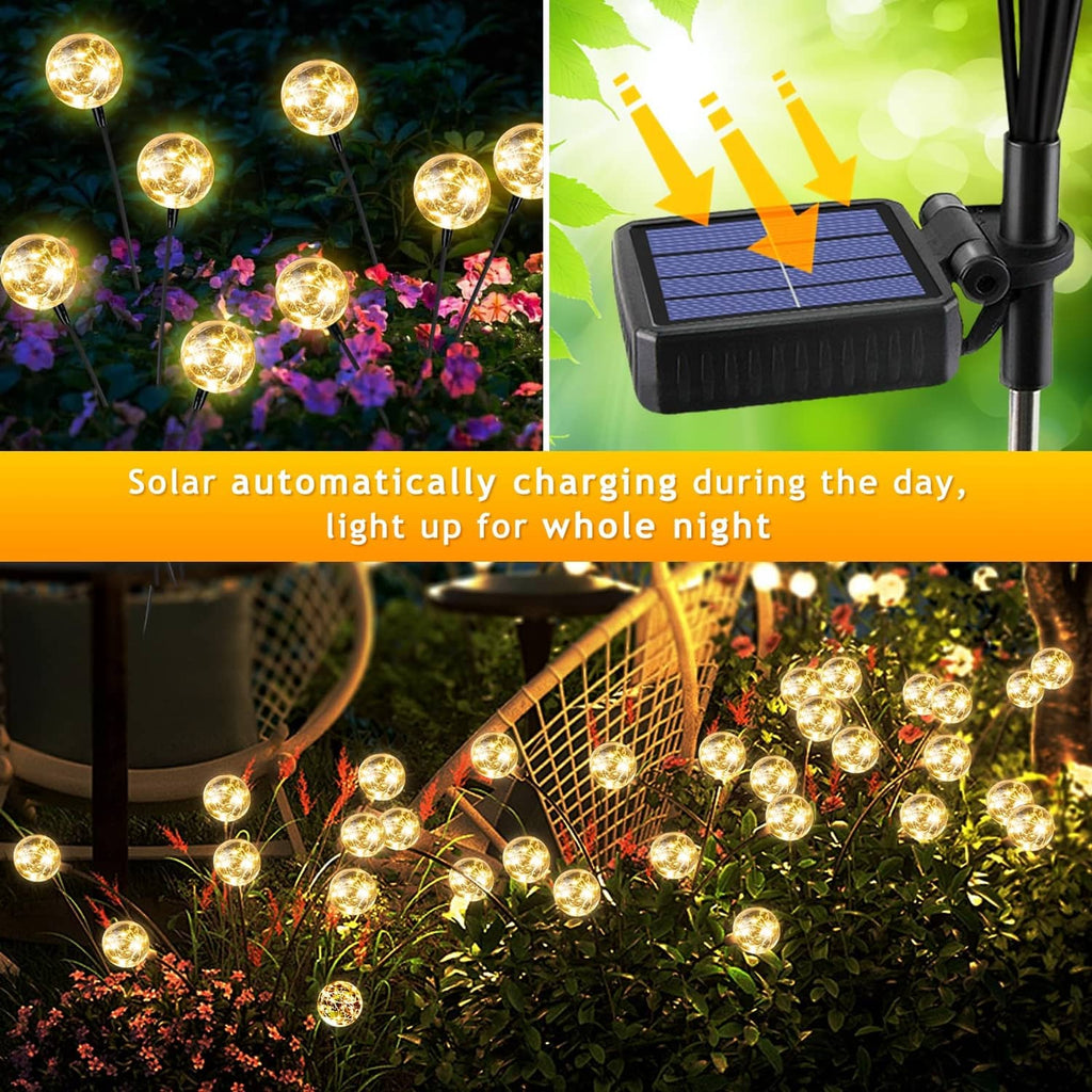 Glowing warm white solar globe lights on multiple stems beside flowers