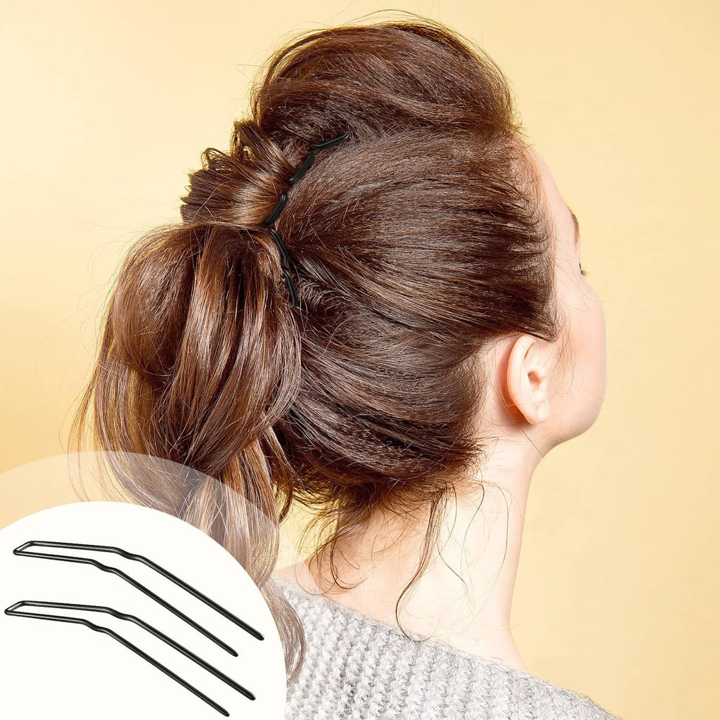 Black U-shaped hairpins securing a side bun hairstyle, pins near hairline