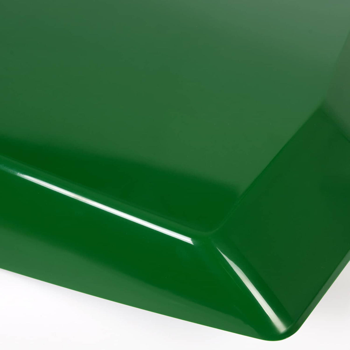 Close-up of green hood surface with silver edge trim and seam