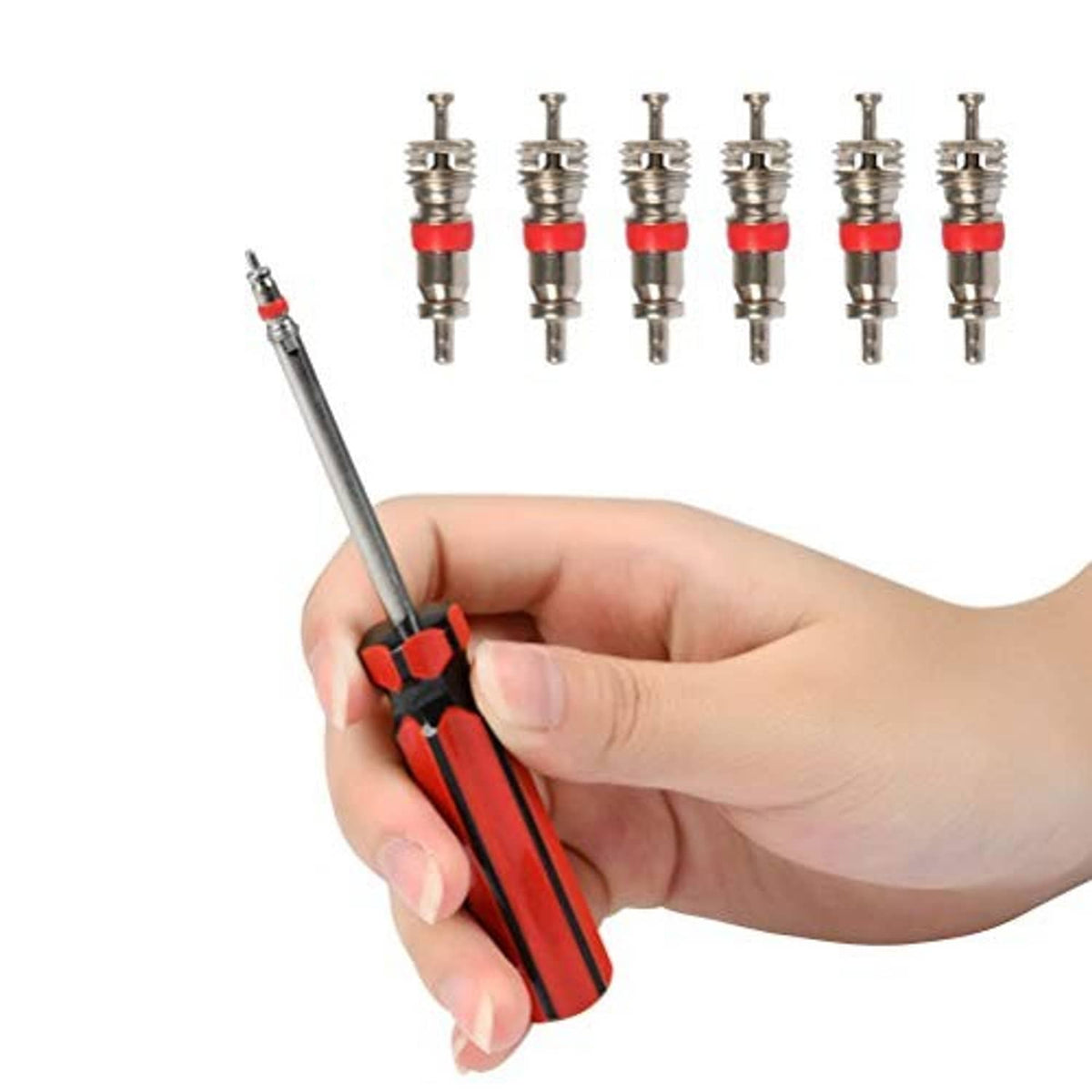 Hand holding red valve stem tool with multiple valve cores on metal stems