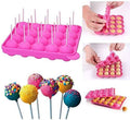 Pink silicone cake pop mold with stick-insert tray and decorated cake pops