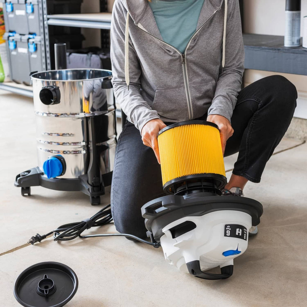 Shop vac with mounted yellow pleated filter cartridge and black lid