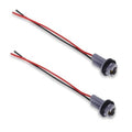Two car light bulb pigtail sockets with gray housings and red/black wire leads