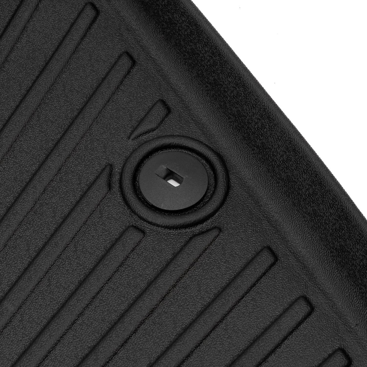Black TPE cargo liner with round retention fastener and raised ribbed texture