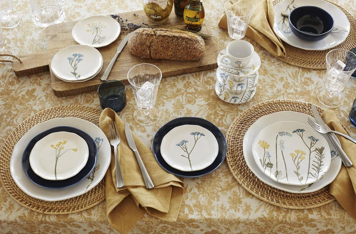 Appetizer plates with white center, navy trim, and botanical stem designs