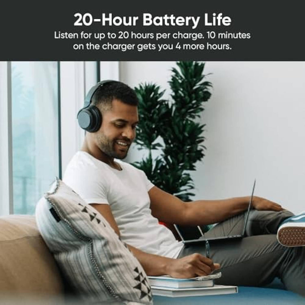 Over-ear wireless noise-cancelling headphones worn by a seated person.