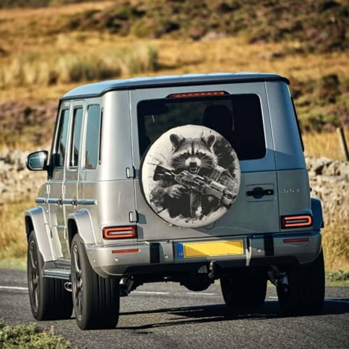 Raccoon spare tire cover on rear of a blue vehicle