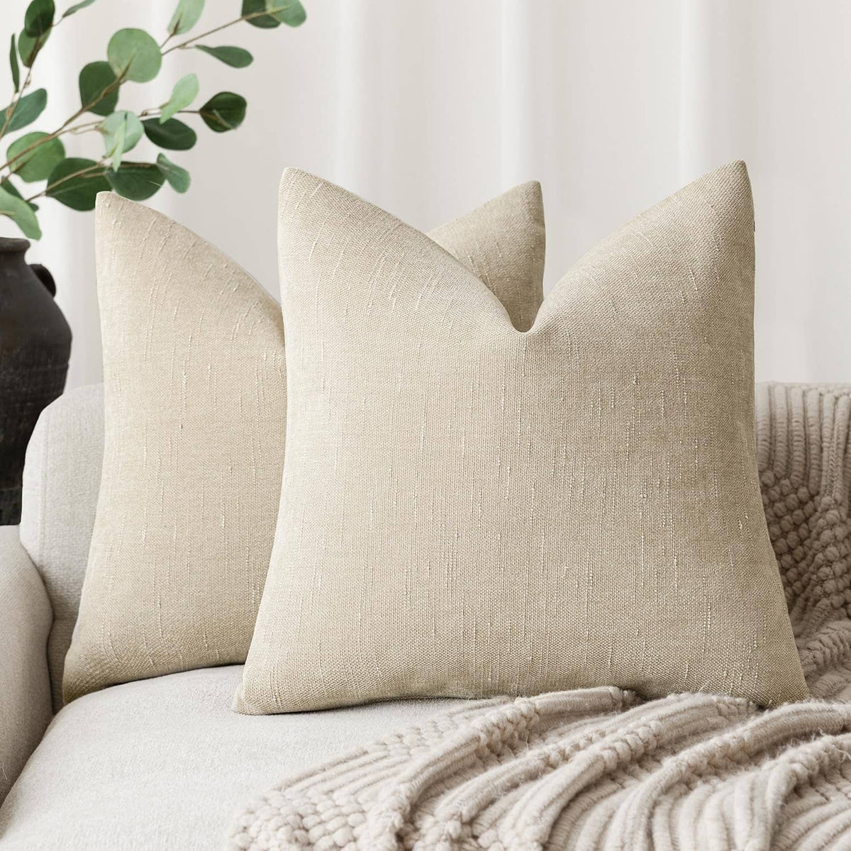 Cement textured chenille throw pillow, beige square cushion with stitched seam lines.