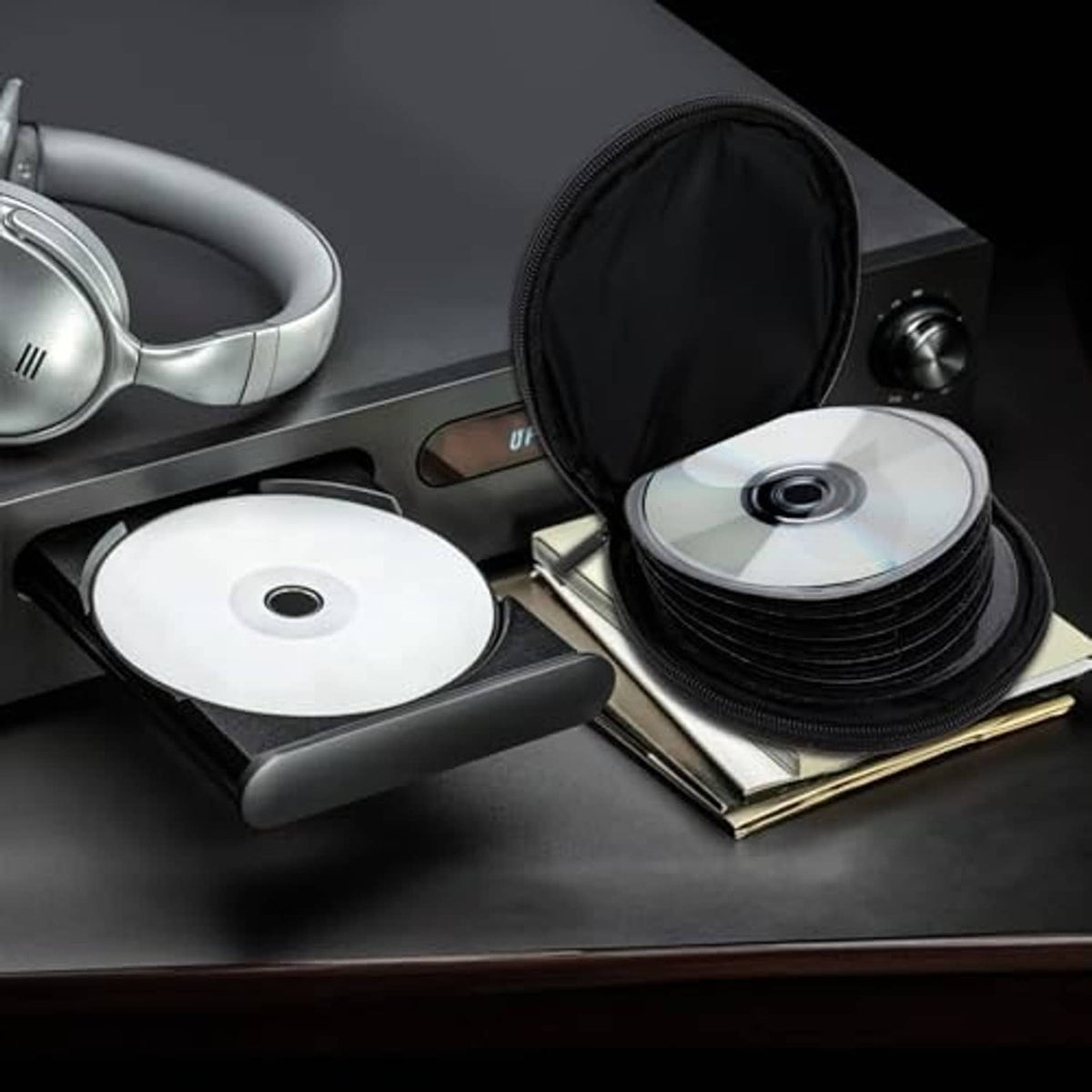 Black round CD/DVD storage pouch with zipper, displayed with stacked discs
