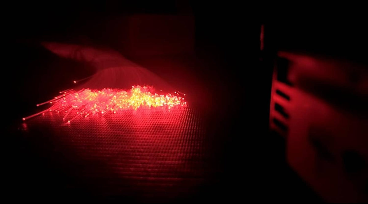 Fiber optic light strands with red end glow, dense illuminated tips
