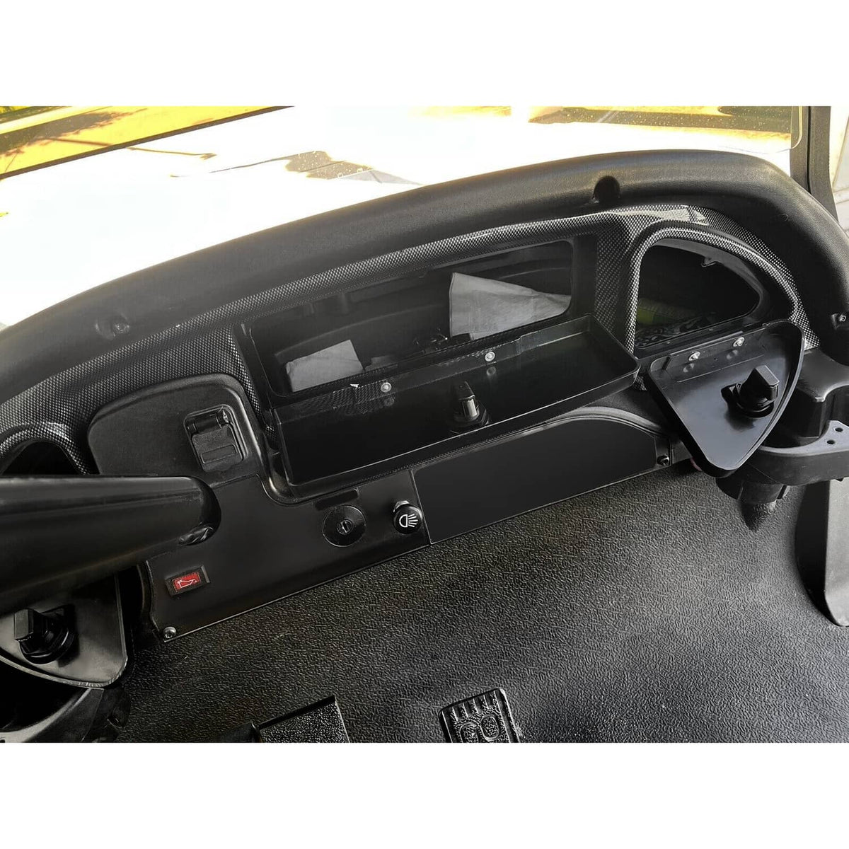 Installed dash locking door with carbon-fiber-look trim and open storage compartment