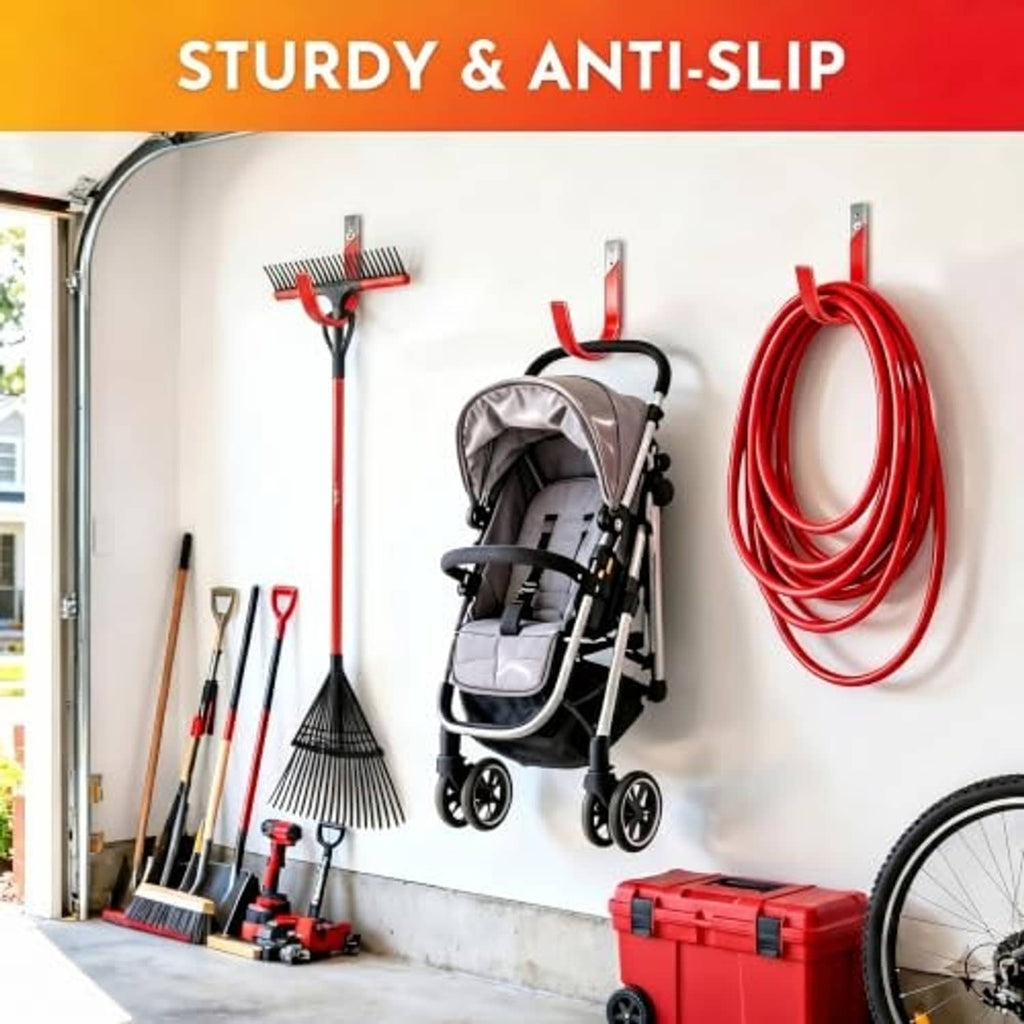 Multiple red and black wall hooks mounted on wall, holding yard and garden items