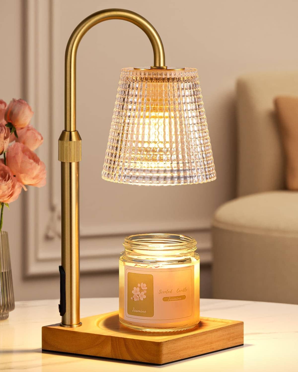 Brass candle warmer lamp with clear textured shade and glass jar on wooden base