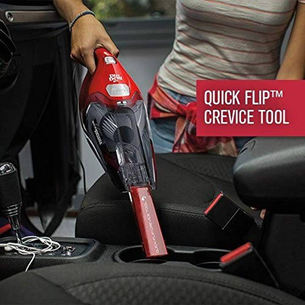 Red handheld vacuum in use, held above car seat with crevice tool