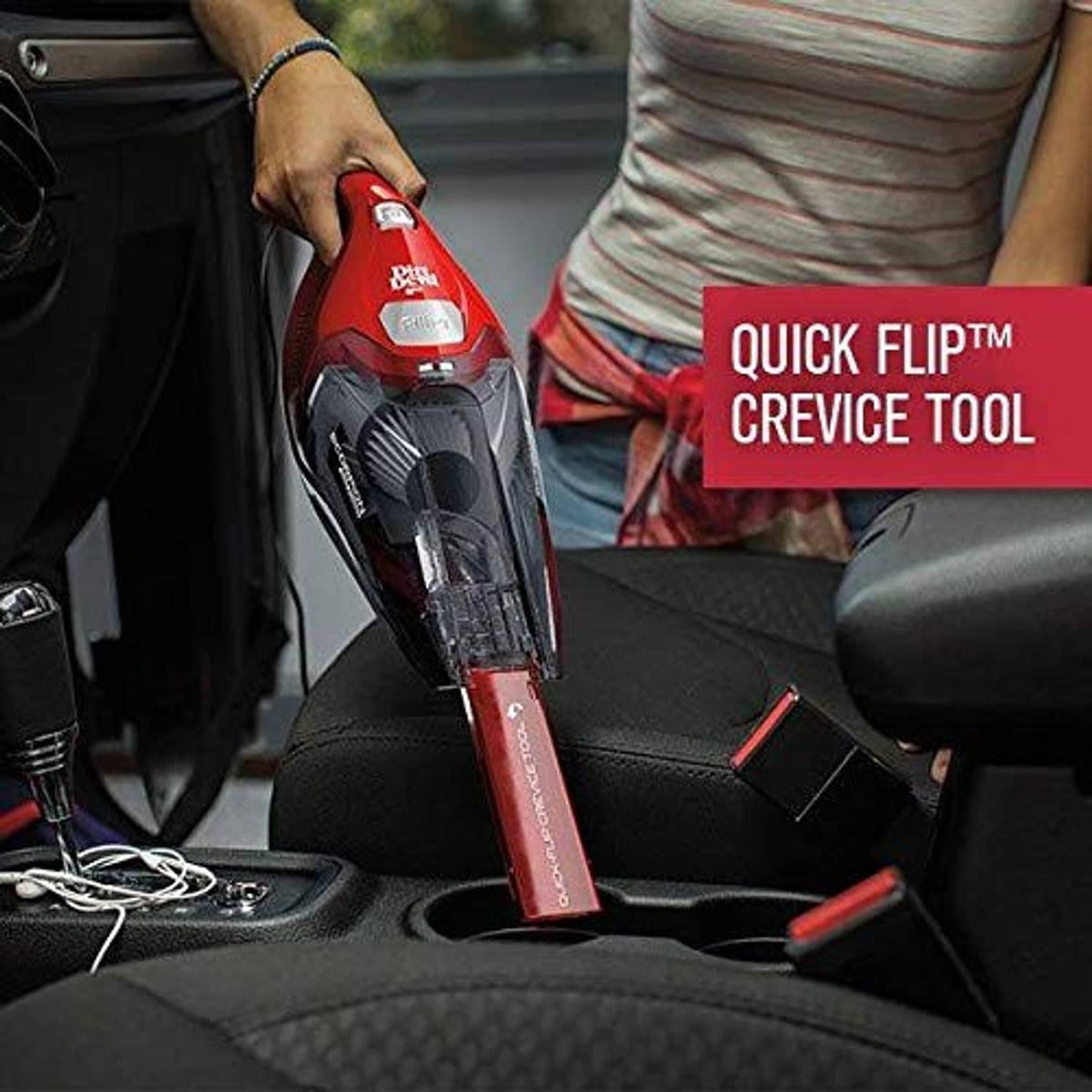 Red handheld vacuum in use, held above car seat with crevice tool